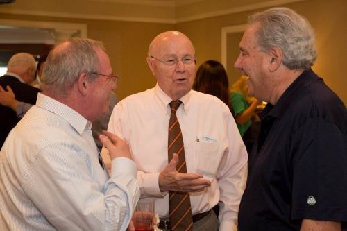 Bruce and other attorneys from the firm standing in a group, talking to one another